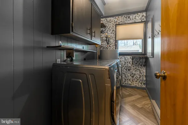 a utility room with closet dryer and washer