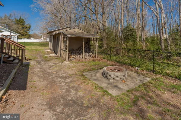 a backyard of a house with yard barbeque oven and outdoor seating