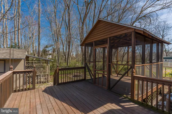 a view of a wooden deck next to a yard
