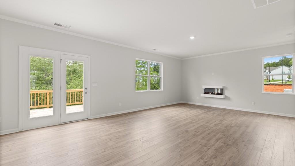 174 Thompson Ridge Lane Dallas, GA 30132 - Photo 13 of 35 a view of an empty room with a window and wooden floor