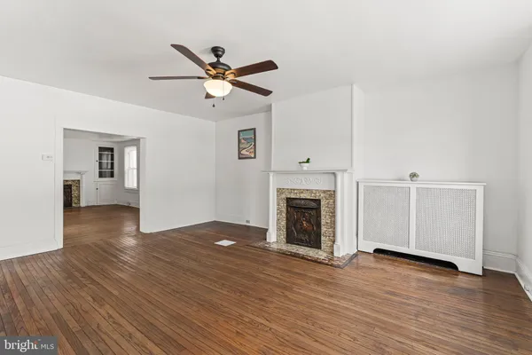 a view of a livingroom with a hardwood floor and a ceiling fan