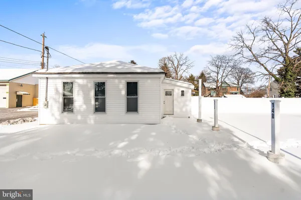 a view of a house with a snow on the road