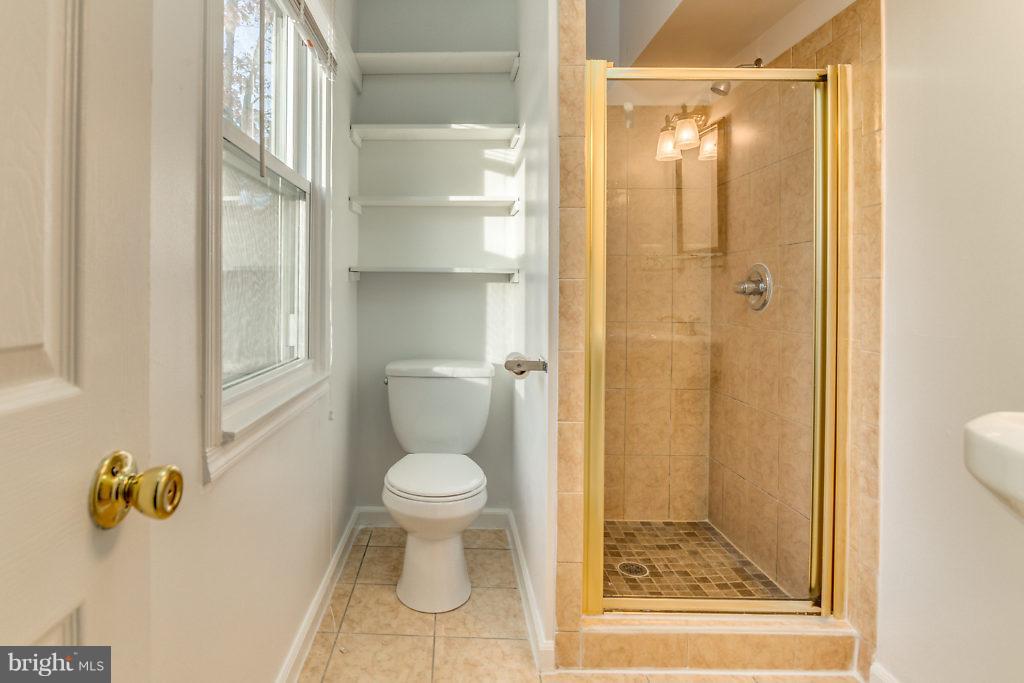 7732 Matisse Way Springfield, VA 22153 - Photo 24 of 30 a bathroom with a toilet and a shower