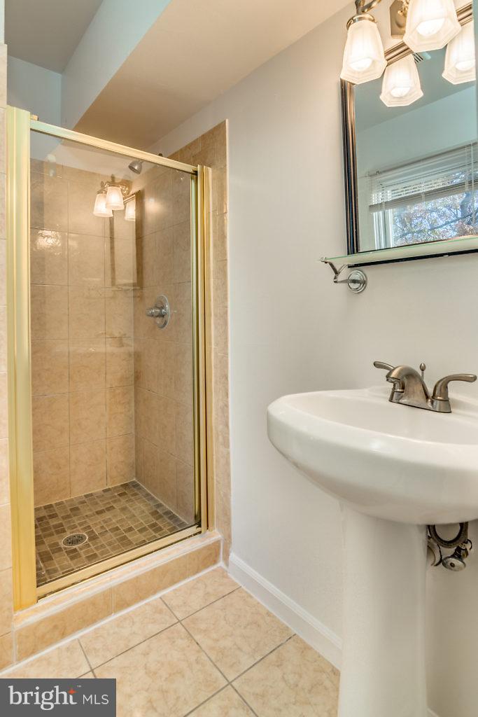 7732 Matisse Way Springfield, VA 22153 - Photo 25 of 30 a bathroom with a sink a mirror and shower