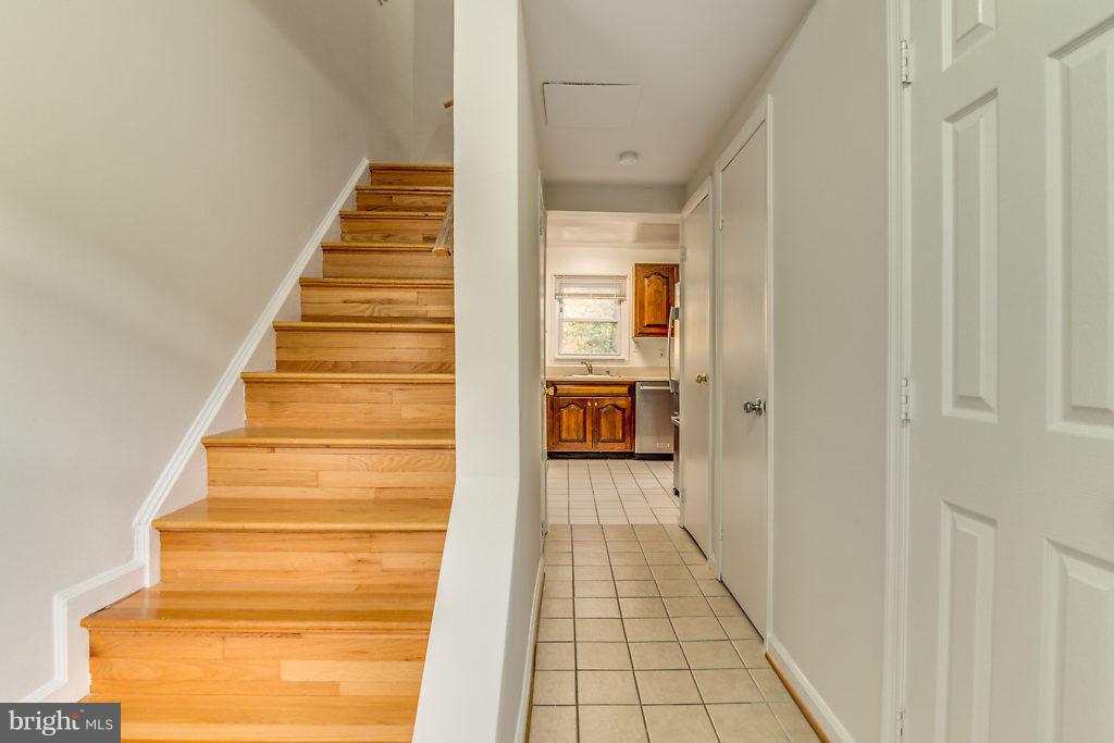 7732 Matisse Way Springfield, VA 22153 - Photo 5 of 30 a view of a hallway with wooden floor and entryway