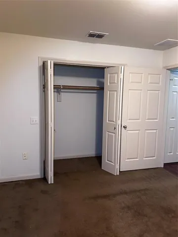 an empty room with closet area