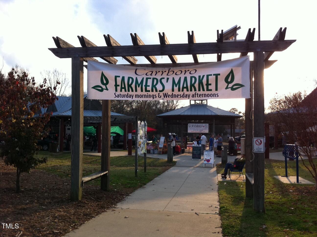 130 Two Hills Drive, Unit 102B Carrboro, NC 27510 - Photo 17 of 18 a view of a cafe with a table and chairs under an umbrella