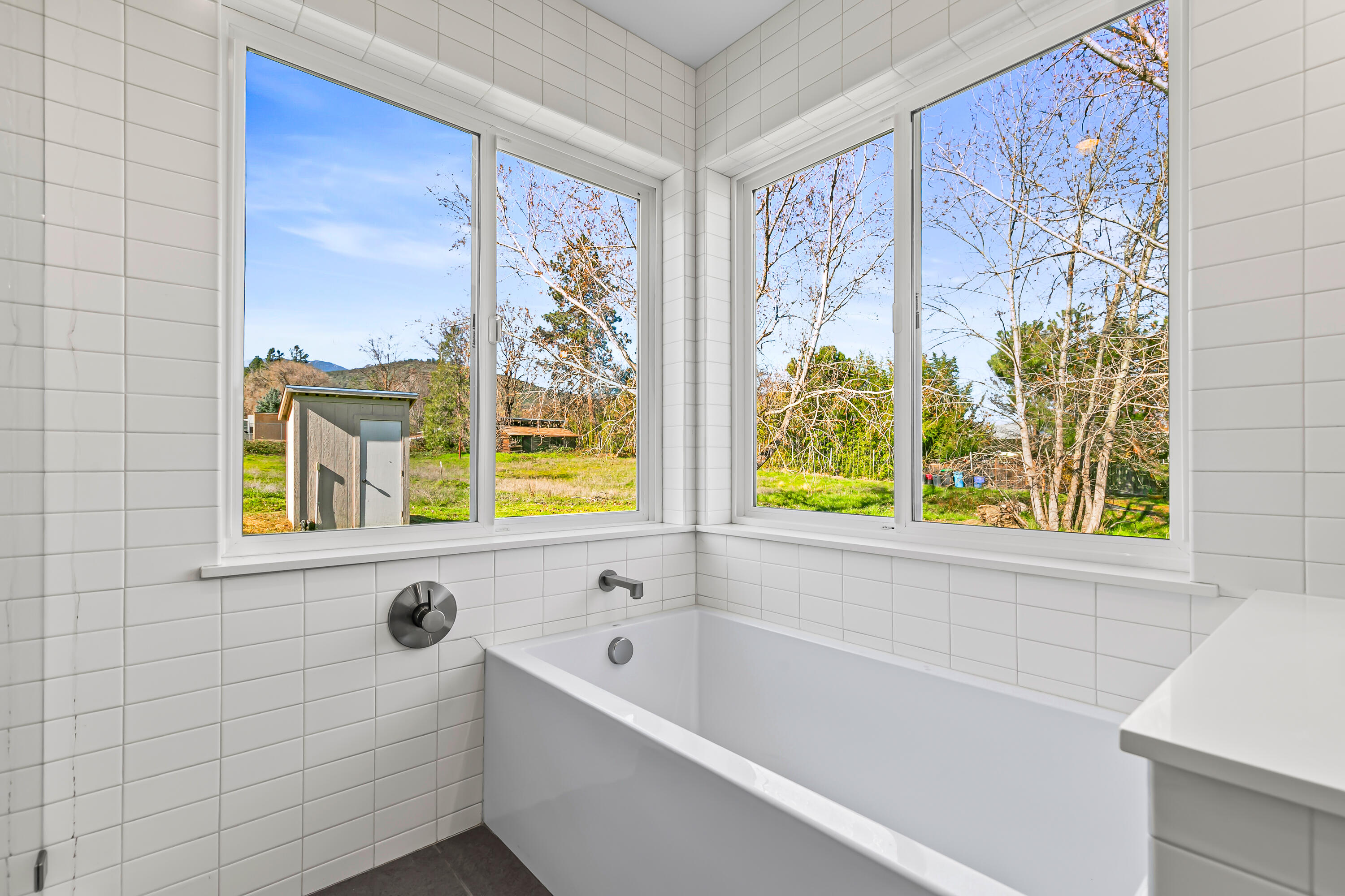 593 Crowson Road Ashland, OR 97520 - Photo 16 of 36 a bathroom with a bathtub and a window