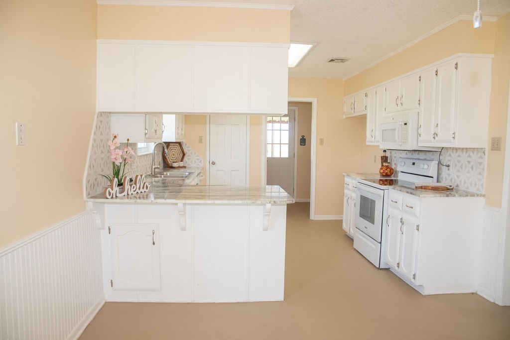 261 Rabbit Hill Lorena, TX 76655 - Photo 11 of 50 a kitchen with granite countertop white cabinets and white appliances