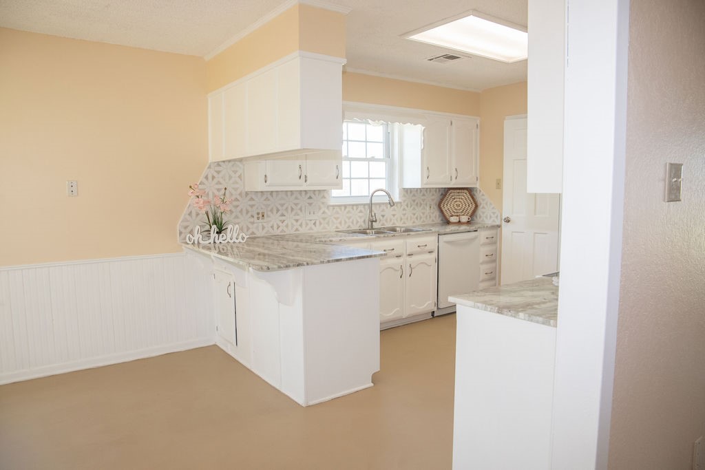 261 Rabbit Hill Lorena, TX 76655 - Photo 12 of 50 a kitchen with stainless steel appliances granite countertop a sink and a white cabinets