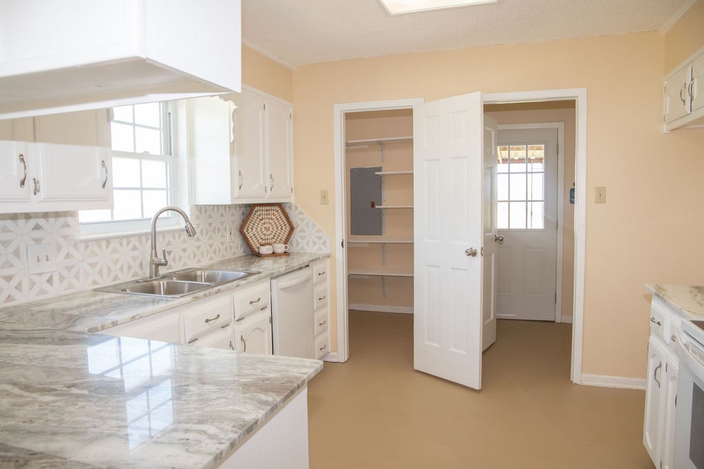 261 Rabbit Hill Lorena, TX 76655 - Photo 14 of 50 a kitchen with granite countertop a sink and a stove