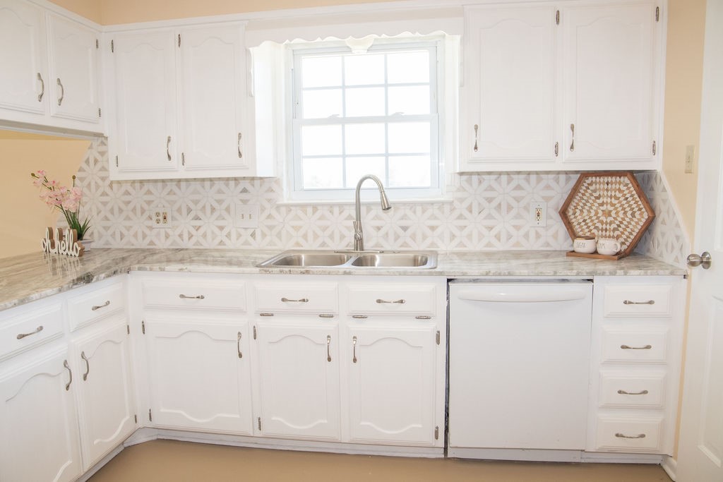 261 Rabbit Hill Lorena, TX 76655 - Photo 15 of 50 a kitchen with granite countertop white cabinets and sink
