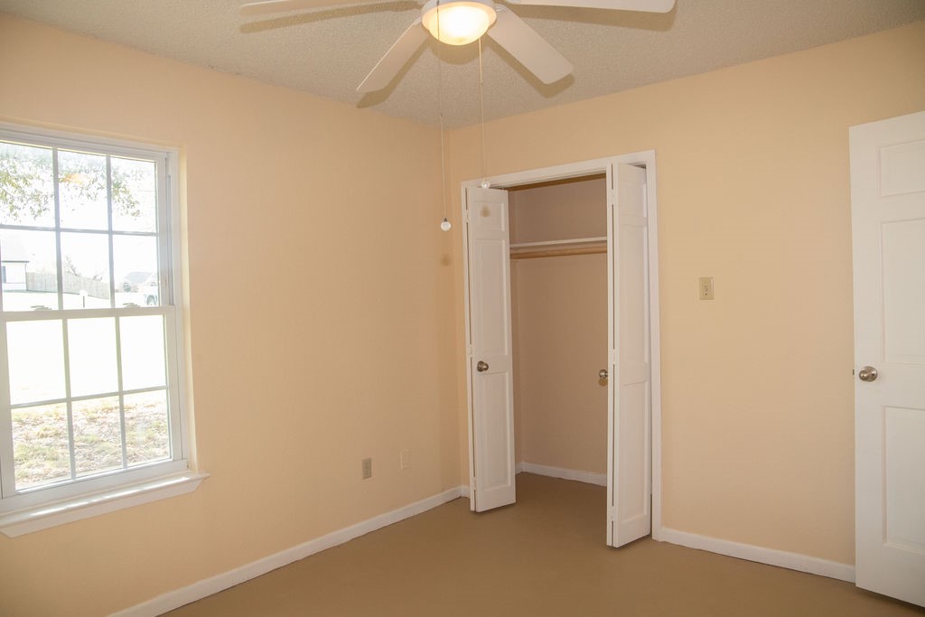 261 Rabbit Hill Lorena, TX 76655 - Photo 24 of 50 an empty room with a window and a chandelier fan