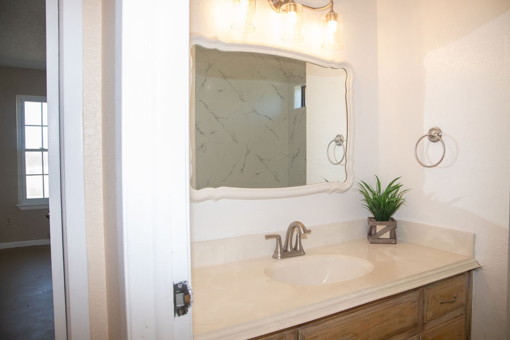 261 Rabbit Hill Lorena, TX 76655 - Photo 26 of 50 a bathroom with a sink a mirror and a shower