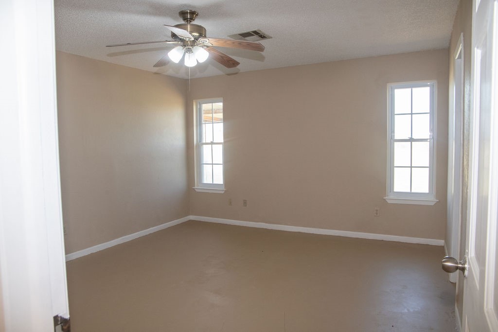 261 Rabbit Hill Lorena, TX 76655 - Photo 28 of 50 an empty room with windows and fan
