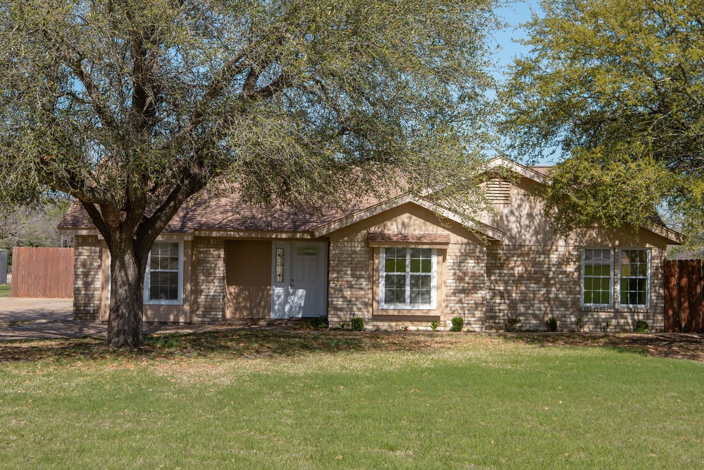 261 Rabbit Hill Lorena, TX 76655 - Photo 49 of 50 a front view of a house with a garden and trees