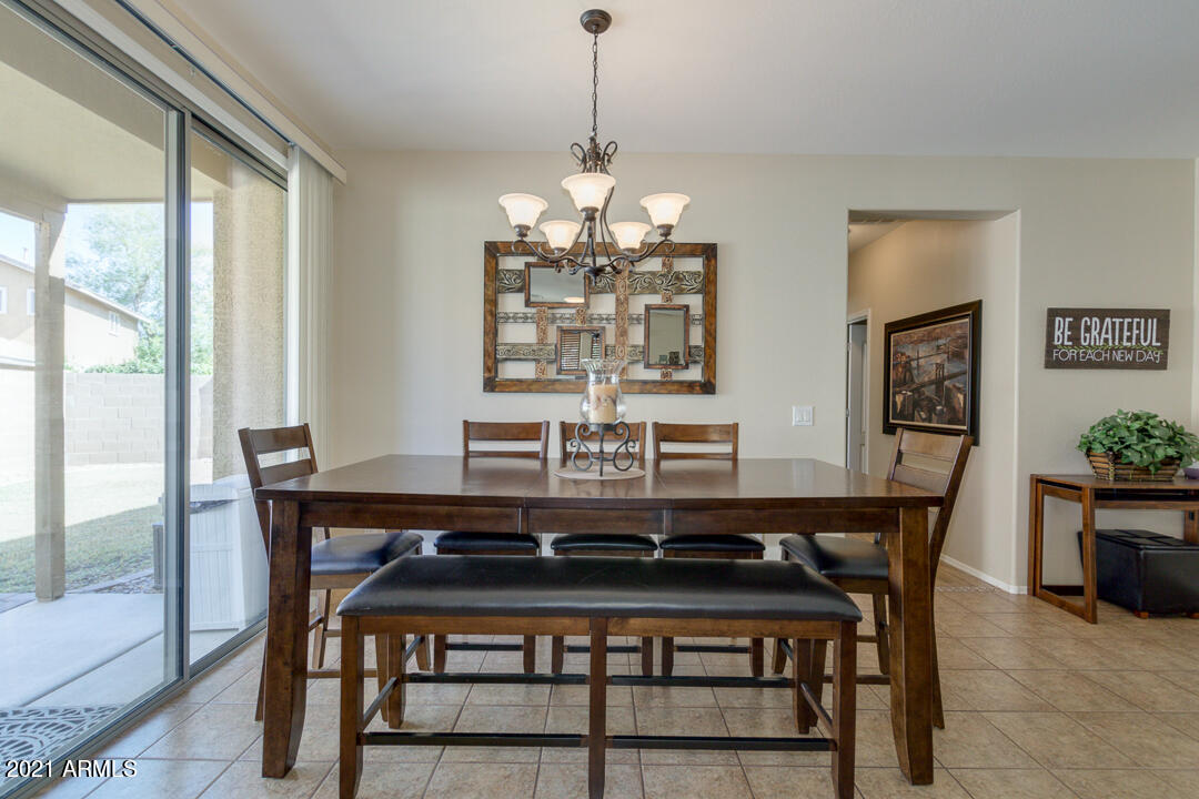 3763 East Larson Lane Gilbert, AZ 85295 - Photo 11 of 40 a view of a dining room with furniture window and wooden floor