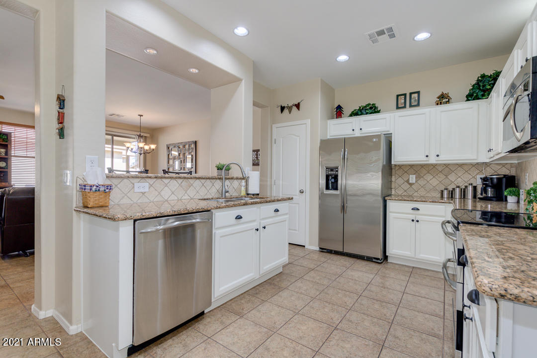 3763 East Larson Lane Gilbert, AZ 85295 - Photo 15 of 40 a kitchen with stainless steel appliances granite countertop a refrigerator and a sink