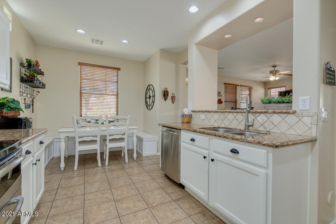 3763 East Larson Lane Gilbert, AZ 85295 - Photo 17 of 40 a large kitchen with kitchen island granite countertop a large counter top and sink