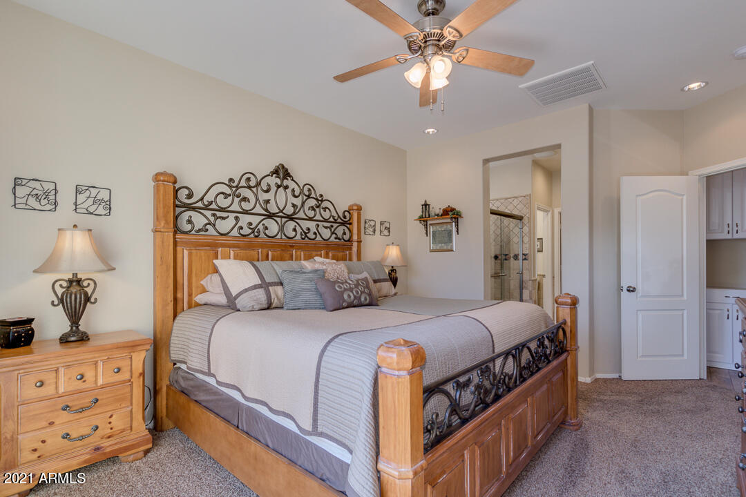 3763 East Larson Lane Gilbert, AZ 85295 - Photo 20 of 40 a bedroom with a bed and a chandelier