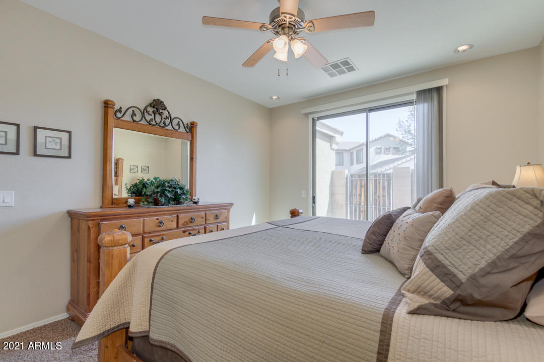 3763 East Larson Lane Gilbert, AZ 85295 - Photo 22 of 40 a bedroom with a bed and a chandelier