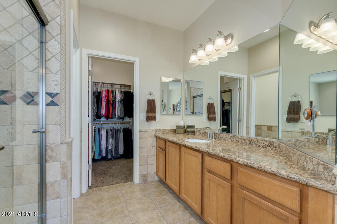 3763 East Larson Lane Gilbert, AZ 85295 - Photo 25 of 40 a spacious bathroom with a granite countertop sink a mirror and a shower