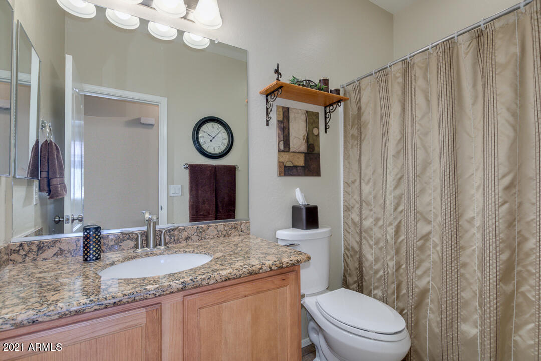 3763 East Larson Lane Gilbert, AZ 85295 - Photo 30 of 40 a bathroom with a granite countertop sink mirror vanity and toilet