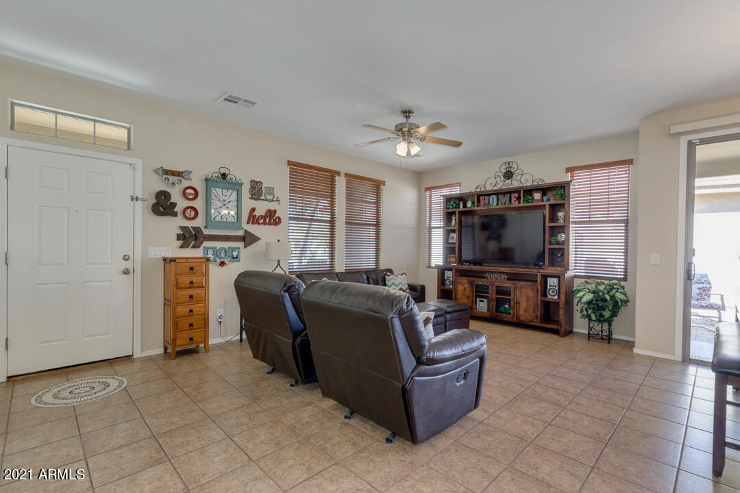 3763 East Larson Lane Gilbert, AZ 85295 - Photo 6 of 40 a living room with furniture a flat screen tv and a window