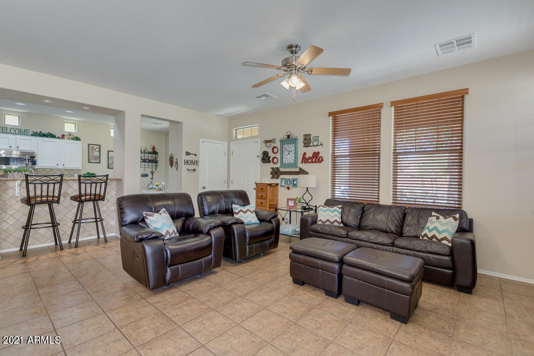 3763 East Larson Lane Gilbert, AZ 85295 - Photo 8 of 40 a living room with furniture and a large window