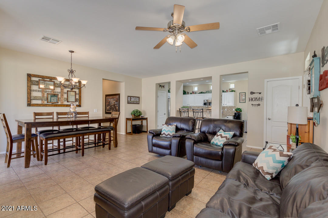 3763 East Larson Lane Gilbert, AZ 85295 - Photo 9 of 40 a living room with furniture kitchen view and a chandelier