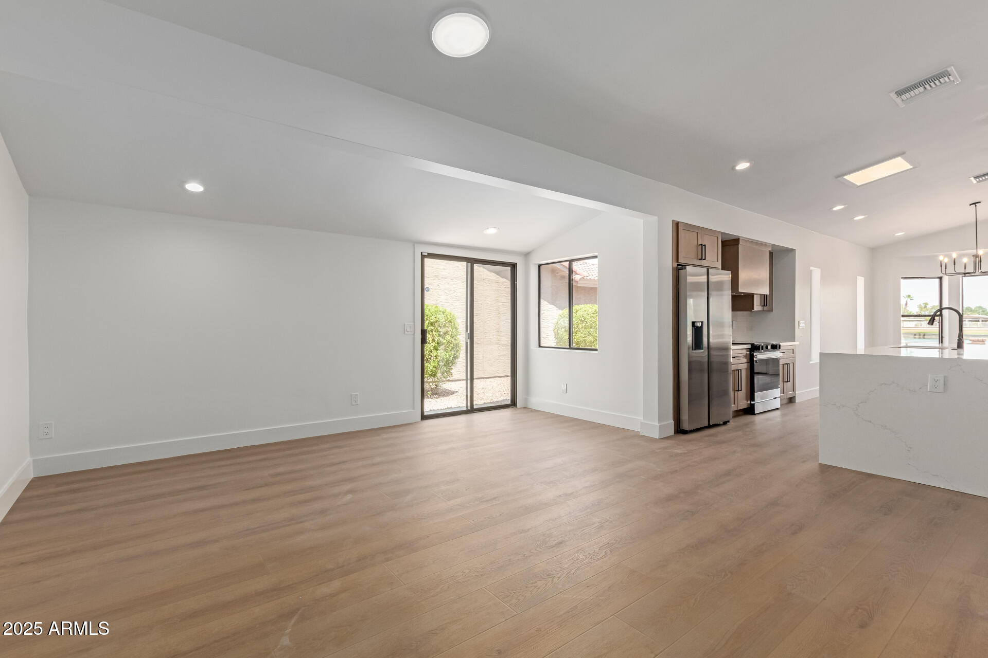 8883 East Fairway Boulevard Sun Lakes, AZ 85248 - Photo 16 of 30 a view of an empty room with window and wooden floor