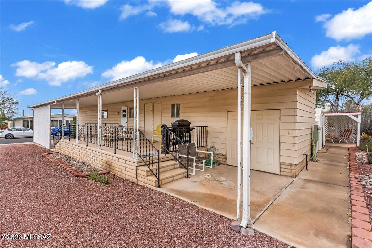 5840 West Flying W Street Tucson, AZ 85713 - Photo 28 of 38 a view of a patio with table and chairs and potted plants
