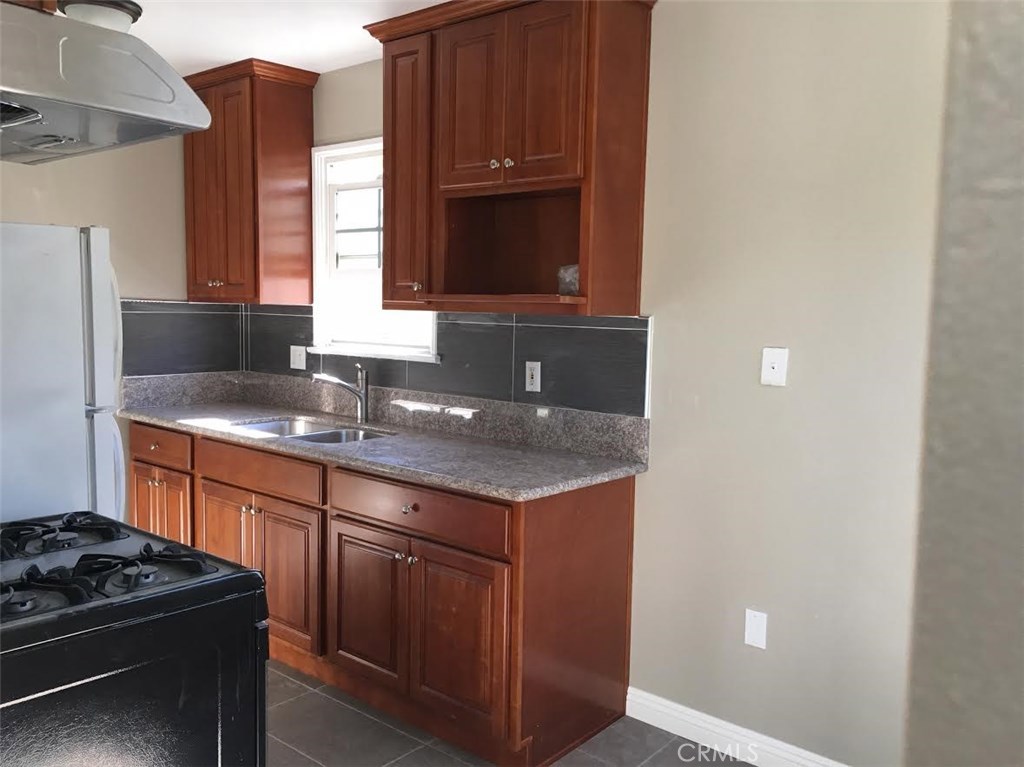 500 North Electric Avenue, Unit C Alhambra, CA 91801 - Photo 2 of 5 a kitchen with stainless steel appliances granite countertop a sink and a stove
