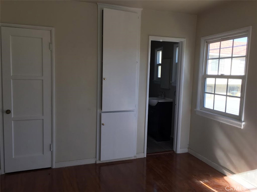 500 North Electric Avenue, Unit C Alhambra, CA 91801 - Photo 4 of 5 an empty room with wooden floor closet and windows