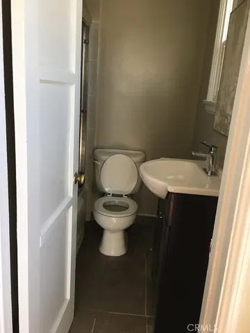 a white toilet sitting next to a bathroom sink