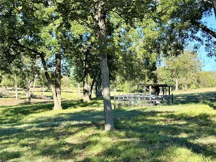 a backyard of a house with swimming pool and outdoor seating