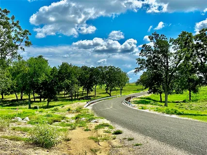 a yard with lots of green space and trees