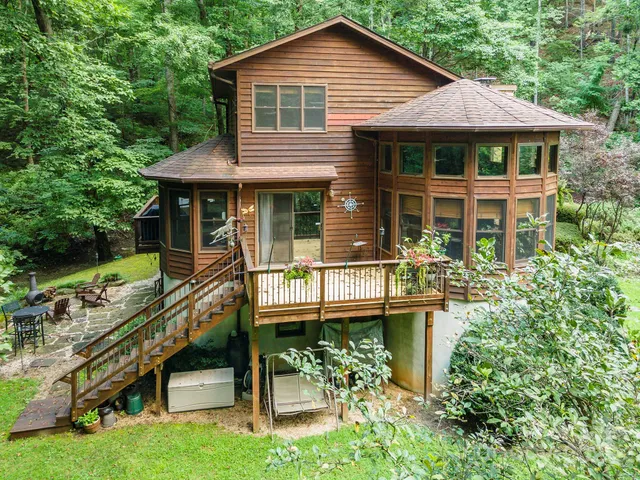 a front view of a house with a yard table and chairs