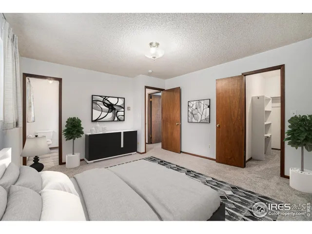 a view of an empty room with closet and a window