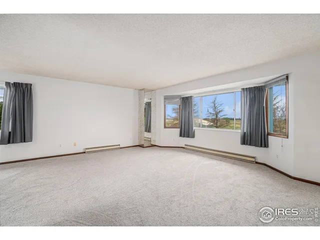 a view of a dining room with furniture and a chandelier