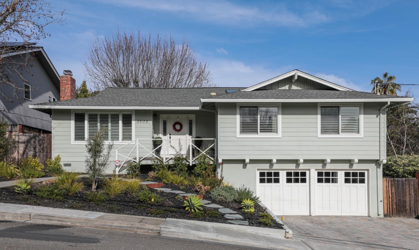 a front view of a house with a garden