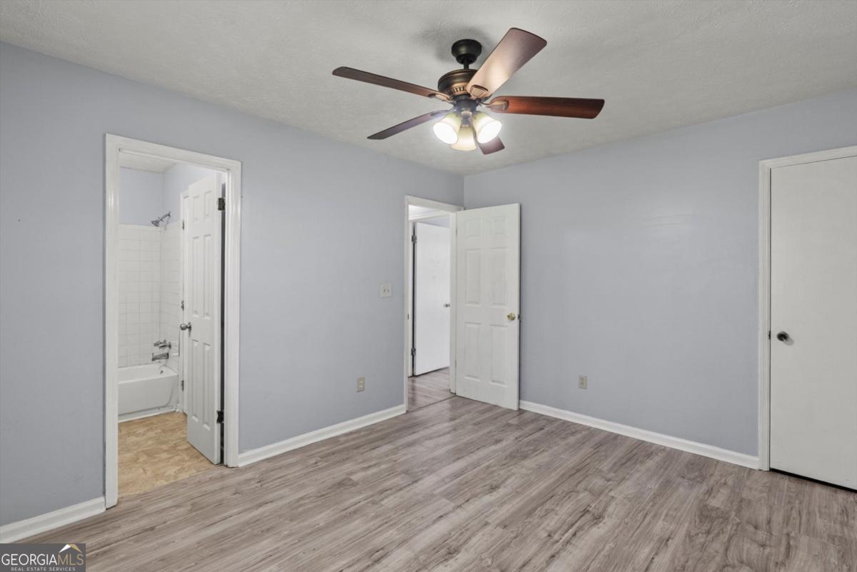 8877 Burnham Way Jonesboro, GA 30238 - Photo 18 of 23 wooden floor in an empty room