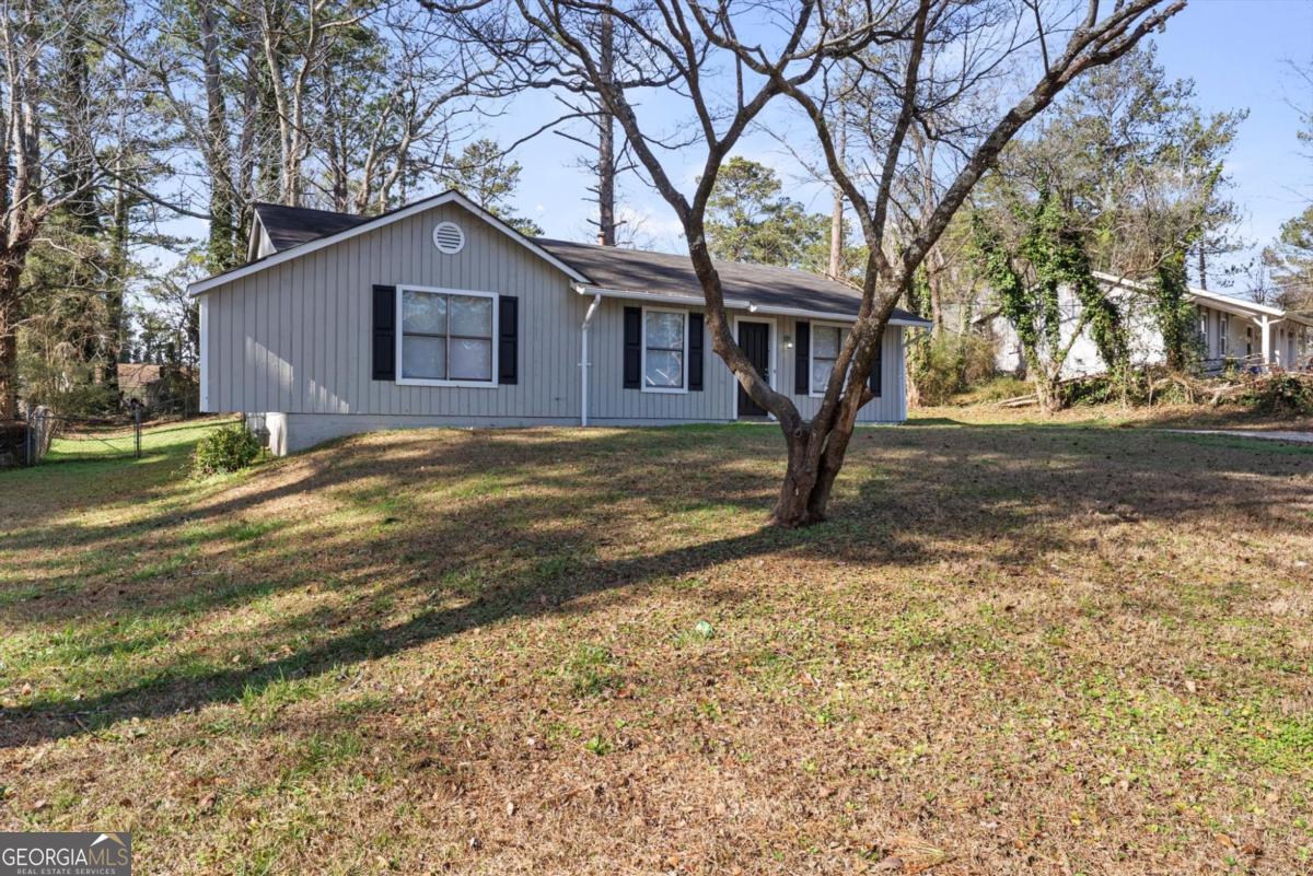 8877 Burnham Way Jonesboro, GA 30238 - Photo 2 of 23 a view of a house with a yard covered in snow