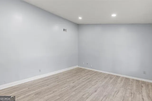 a view of room with wooden floor and fan