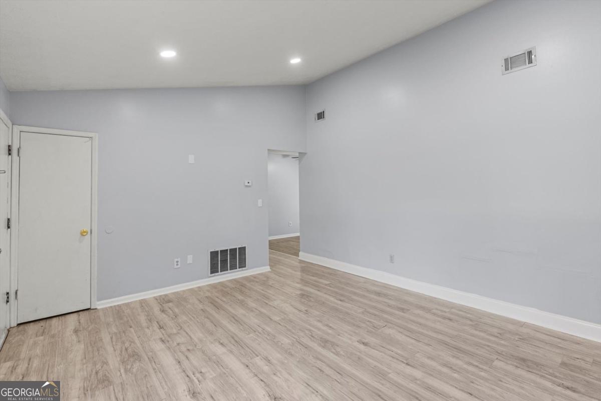 8877 Burnham Way Jonesboro, GA 30238 - Photo 5 of 23 a view of empty room with wooden floor