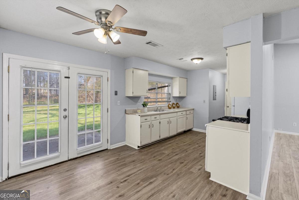 8877 Burnham Way Jonesboro, GA 30238 - Photo 8 of 23 a kitchen with a stove a sink and a refrigerator