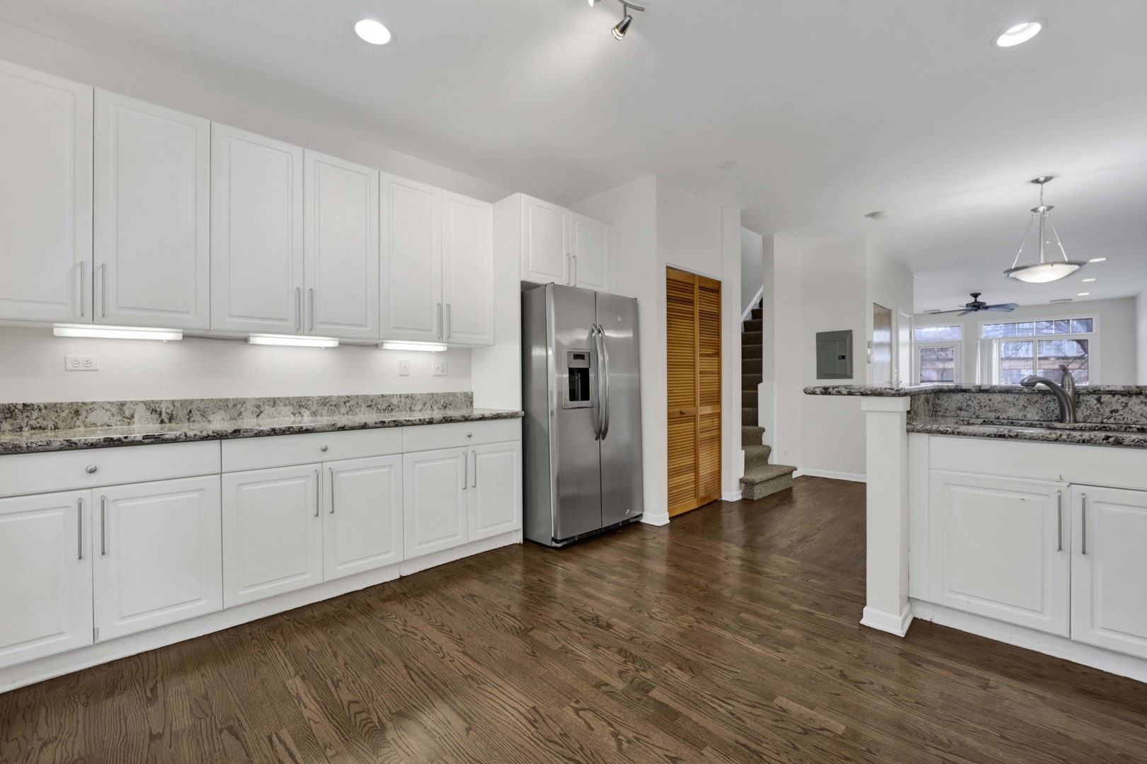 1812 South State Street, Unit 3 Chicago, IL 60616 - Photo 3 of 29 a kitchen with stainless steel appliances granite countertop a refrigerator sink and white cabinets