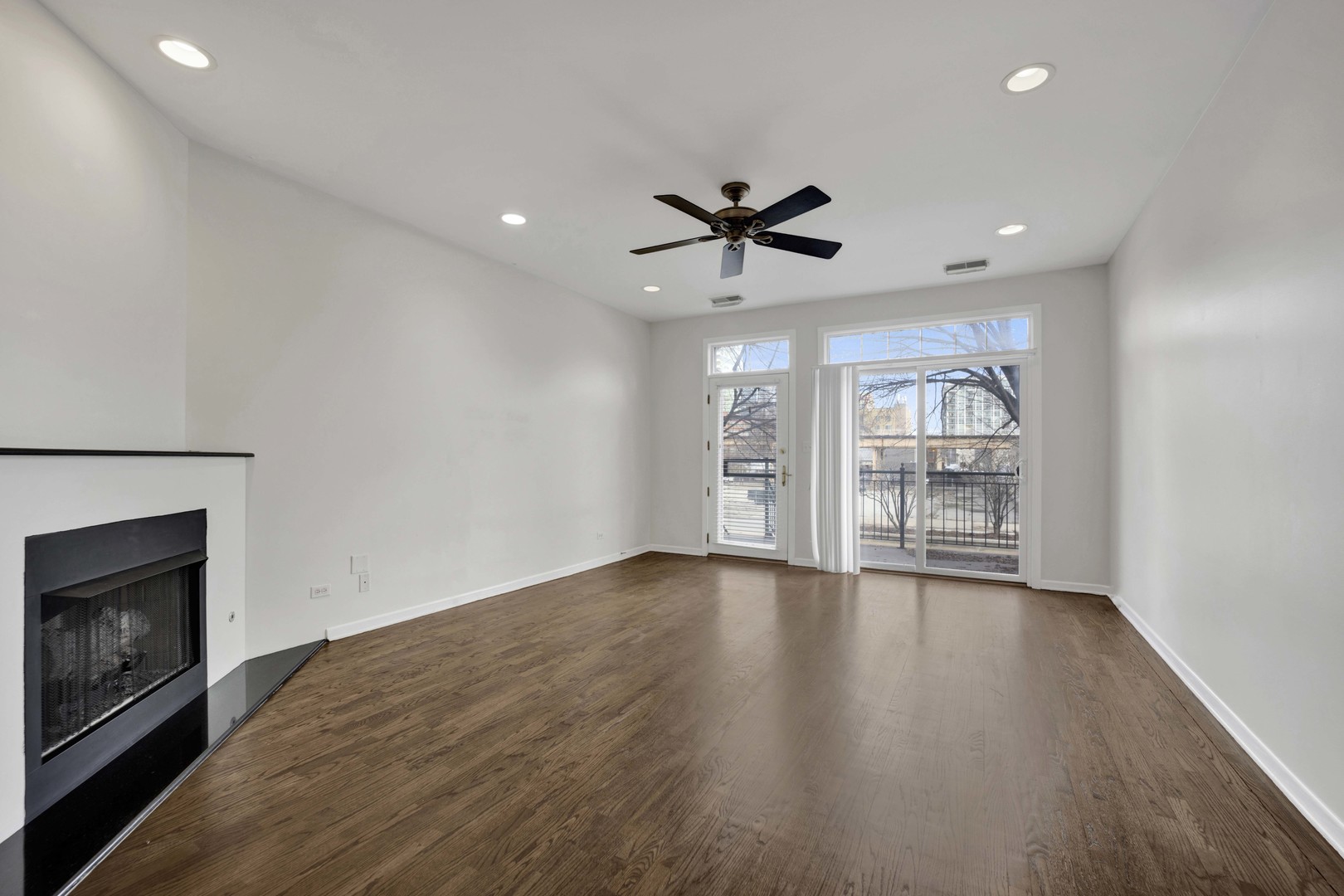 1812 South State Street, Unit 3 Chicago, IL 60616 - Photo 5 of 29 wooden floor in an empty room with a fireplace