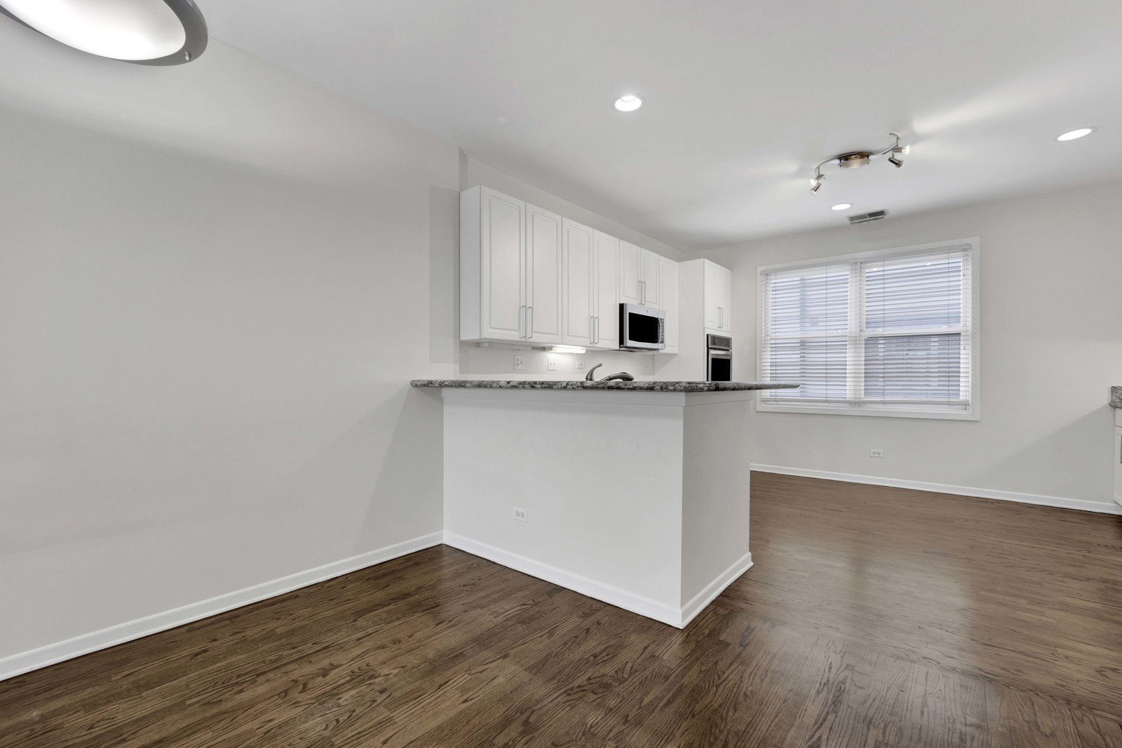 1812 South State Street, Unit 3 Chicago, IL 60616 - Photo 8 of 29 a kitchen with granite countertop white cabinets and white appliances