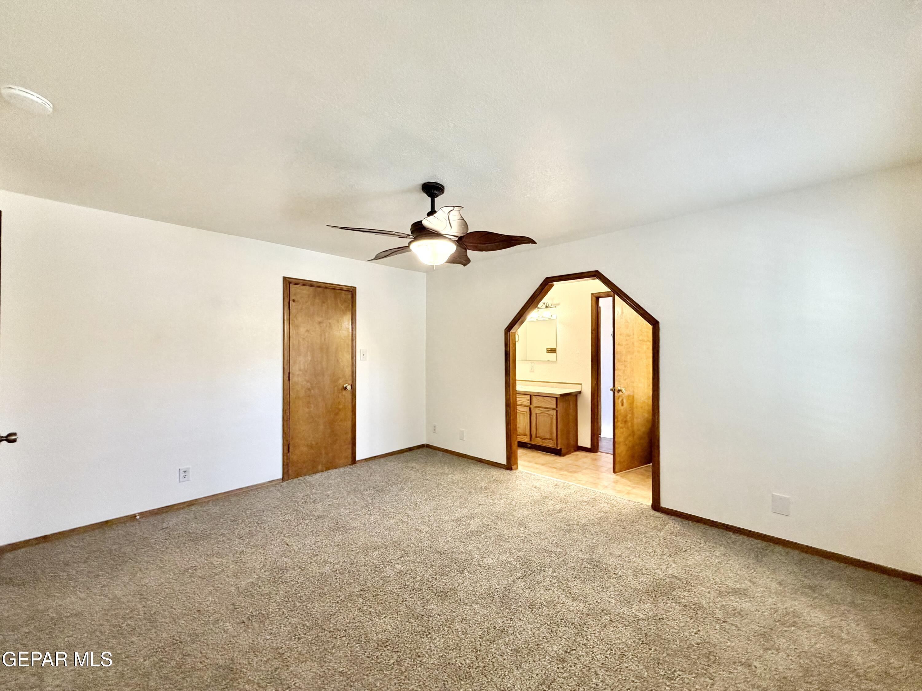 2452 West Ohara Road Anthony, NM 88021 - Photo 15 of 56 a view of a room with a chandelier fan and windows
